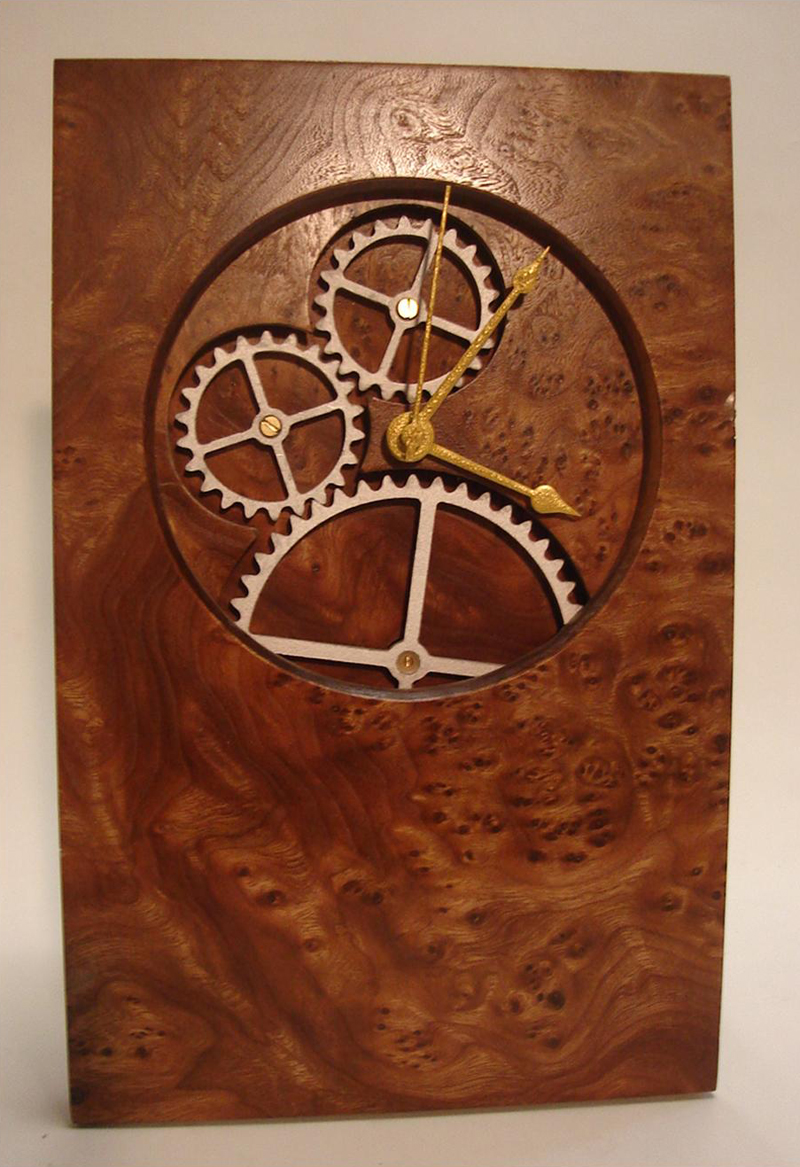 Moving Gear Clock 7.5"w x 11.5"h x 3"d - Secondary mechanism drives the gears which turn at the same rate sas the second hand.  Elm Burl and Walnut.